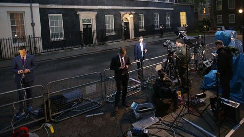Journalists stand outside the PM's residence of 10 Downing Street as they await to hear from David Cameron. (PA Wire)