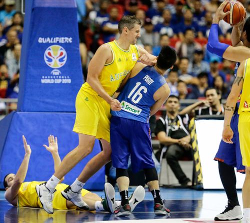 Christopher Goulding lies on the ground as Daniel Kickert of Australia elbows Roger Pogoy of the Philippines during the FIBA Basketball World Cup 2019 Group B qualifier match. Image: EPA