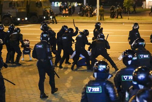 Police use truncheons on protesters during a mass protest following presidential election in Minsk, Belarus