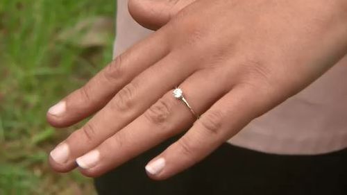 One of the newly engaged couples shows off their ring.