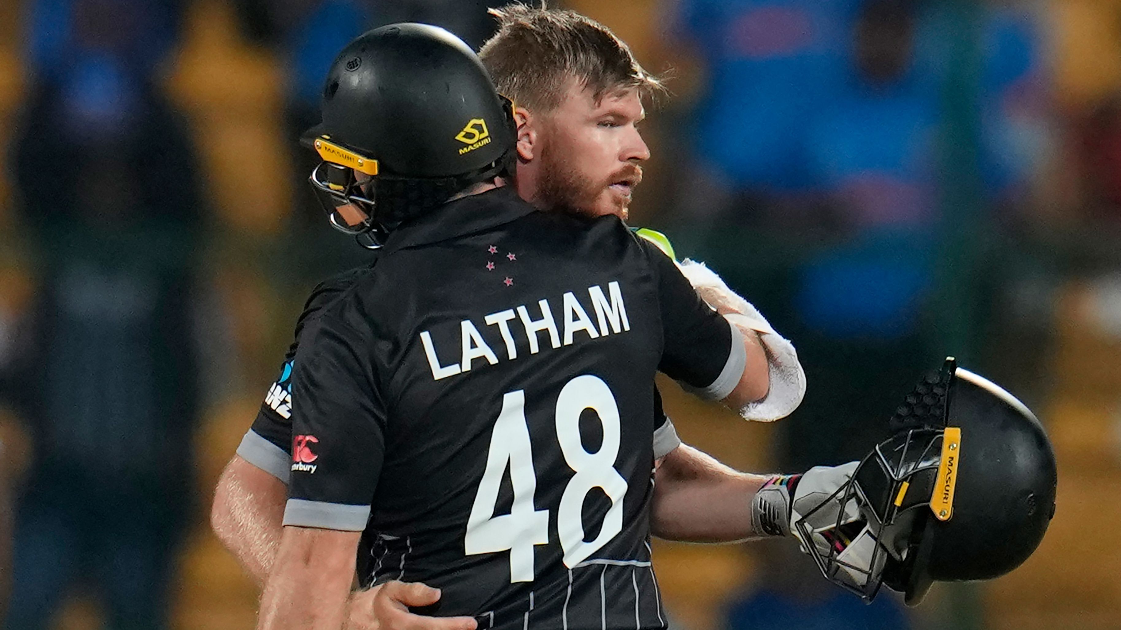 New Zealand&#x27;s Tom Latham hugs batting partner Glenn Phillips to celebrate their win.