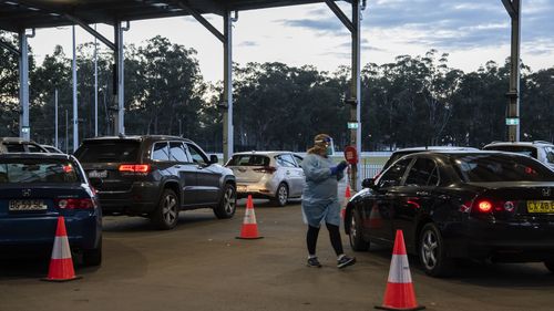 SydPath staff conduct COVID-19 tests at the 24 hour drive through clinic at Fairfield Showgrounds, Sydney.