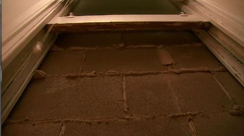 The neighbours have built a wall right up that block's Mr Gordon's bedroom window.