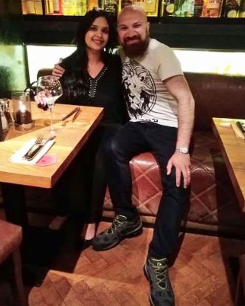 Akbar Badshah, in John's boots, enjoying dinner with his wife. (Akbar Badshah/BBC)