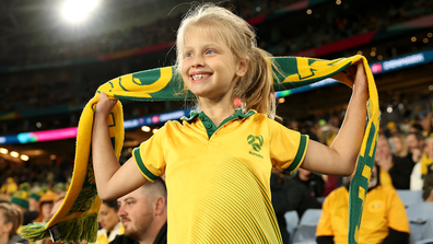 A young Matildas supporter welcomes their team to the field ahead of Australia's round of 16 match against Denmark.