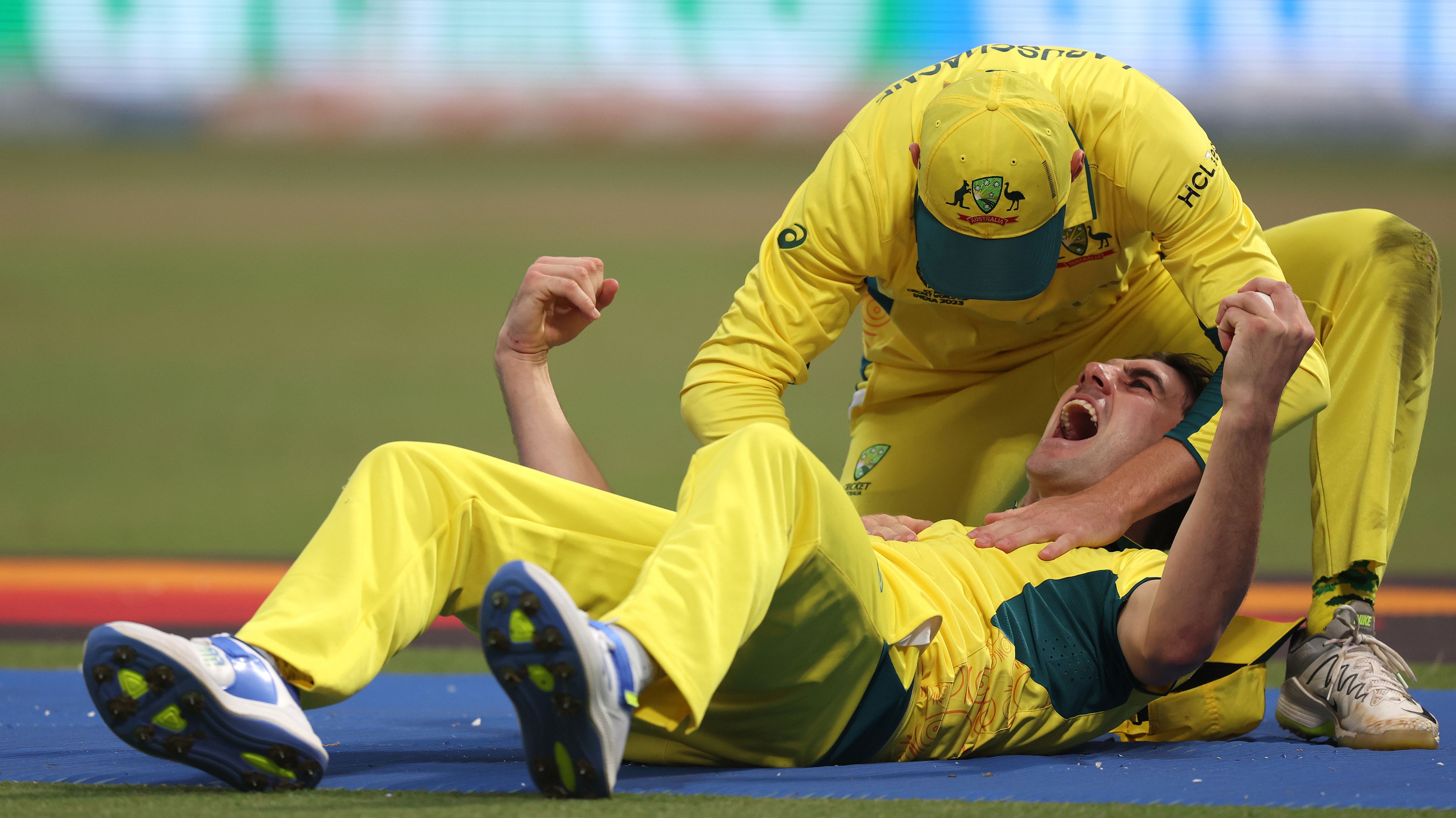 KOLKATA, INDIA - NOVEMBER 16: Pat Cummins of Australia celebrates with teammate Marnus Labuschagne after catching out Quinton de Kock of South Africa (not pictured) during the ICC Men&#x27;s Cricket World Cup India 2023 Semi Final match between South Africa and Australia at Eden Gardens on November 16, 2023 in Kolkata, India. (Photo by Matthew Lewis-ICC/ICC via Getty Images)