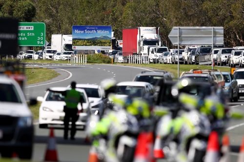 Queensland Police stop vehicles at a checkpoint at the Queensland-New South Wales border in Coolangatta.