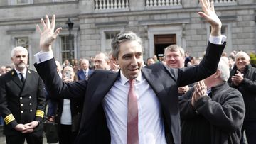 The new Prime Minister of Ireland, Simon Harris gestures as he is applauded by fellow lawmakers outside Leinster House in Dublin, Ireland, Tuesday, April 9, 2024.  