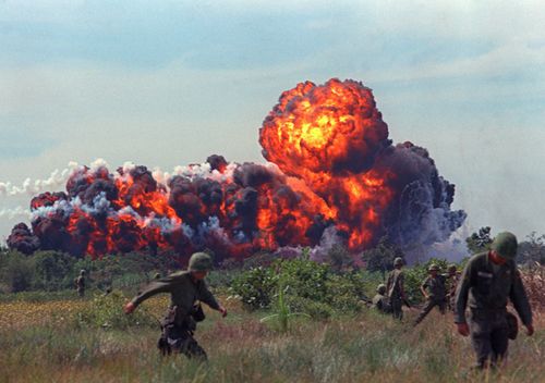 A napalm strike erupts in a fireball near U.S. troops on patrol in South Vietnam, 1966 during the Vietnam War. (AAP)