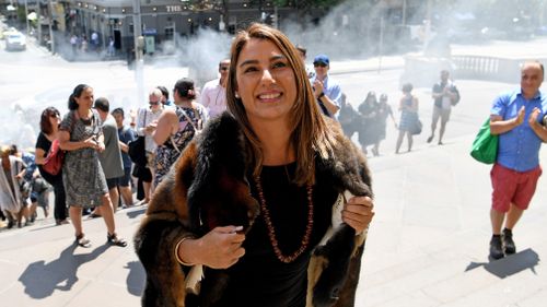 A traditional smoking ceremony is conducted by Aboriginal Elders on the steps of Parliament House for the state's first Aboriginal woman MP and Greens member for Northcote, Lidia Thorpe. (AAP)