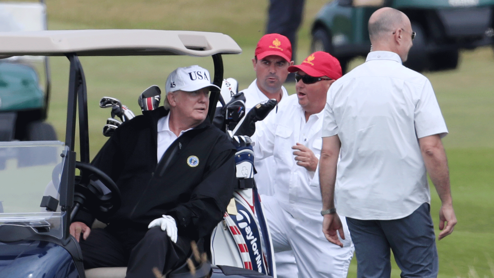 Donald Trump climbs into his golf cart.