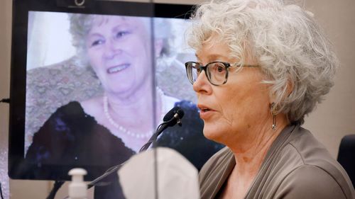 Ann Brooks speaks about her slain mother, Mary Brooks, as a photo of Mary Brooks is displayed by the state during the murder trial of Billy Chemirmir in Dallas, Wednesday, Nov. 17, 2021.