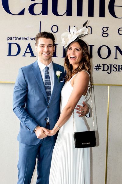 Matty J and partner Laura. Matty is dapper in blue while Laura is traditional in head to toe white accessorised with a bold black clutch and a gorgeous grin.