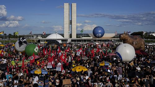 Demonstrators take part in the "Act for the Earth" movement in front of the National Congress in Brasilia, Brazil to demand effective action to contain deforestation in the Amazon. 