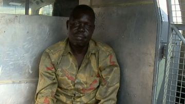 Garang Aguern, a father from Mount Druitt, in the back of a police wagon.
