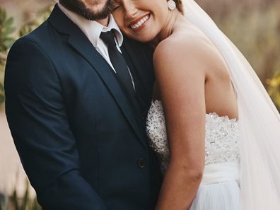 Shot of a happy young couple standing together on their wedding day