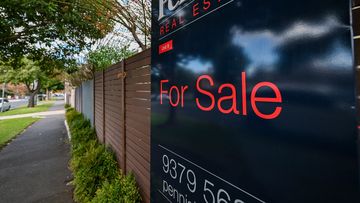 A for sale sign on a home.