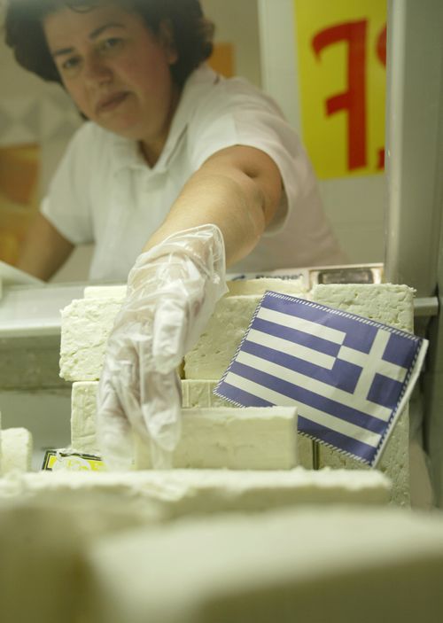 A supermarket worker picks up some feta cheese at a supermarket in central Athens, Greece. In 2005, The European Union's highest court backed Greece's long-running bid to claim exclusive rights to the name of the salty cheese. 