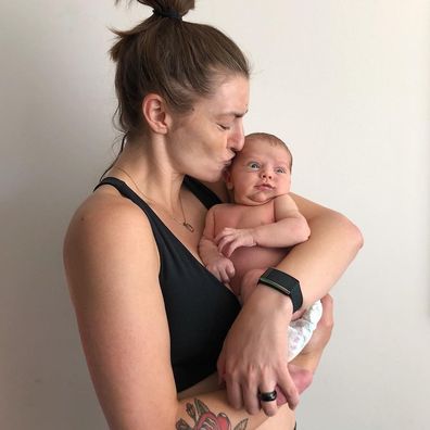 Frances Loch poses with her newborn son.