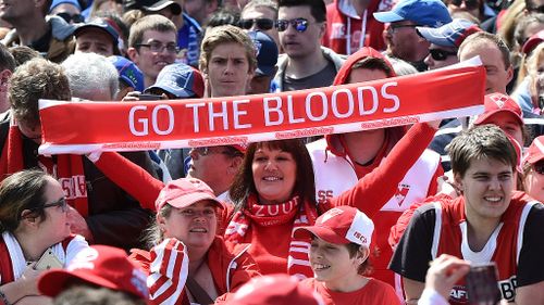 A diehard Swans fan at the AFL Grand Final parade yesterday. (AAP)