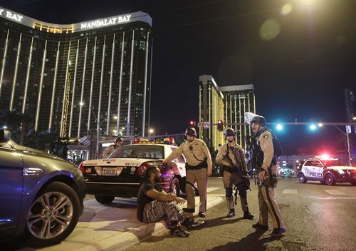 Police officers stand at the scene of a shooting near the Mandalay Bay resort and casino on the Las Vegas Strip. (AP)