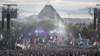 People gather in front of the Pyramid Stage at Worthy Farm in Pilton on June 25, 2017 near Glastonbury, England.