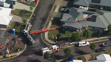 A home in the Queensland city of Ipswich has been left badly damaged after a crane carrying concrete pumping equipment toppled into the property.