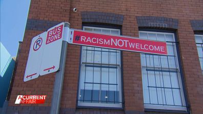 A series of suburban anti-racism signs has sparked a race row at a local council with some claiming they've inadvertently labelled residents as intolerant.