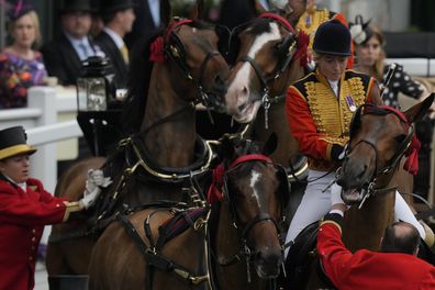 Princess Beatrice, at rear right, reacts as a mounted groom and other try to settle one of the horses leading her carriage on the fifth day of the Royal Ascot horserace meeting, at Ascot Racecourse, in Ascot, England, Saturday, June 18, 2022. (AP Photo/Alastair Grant)