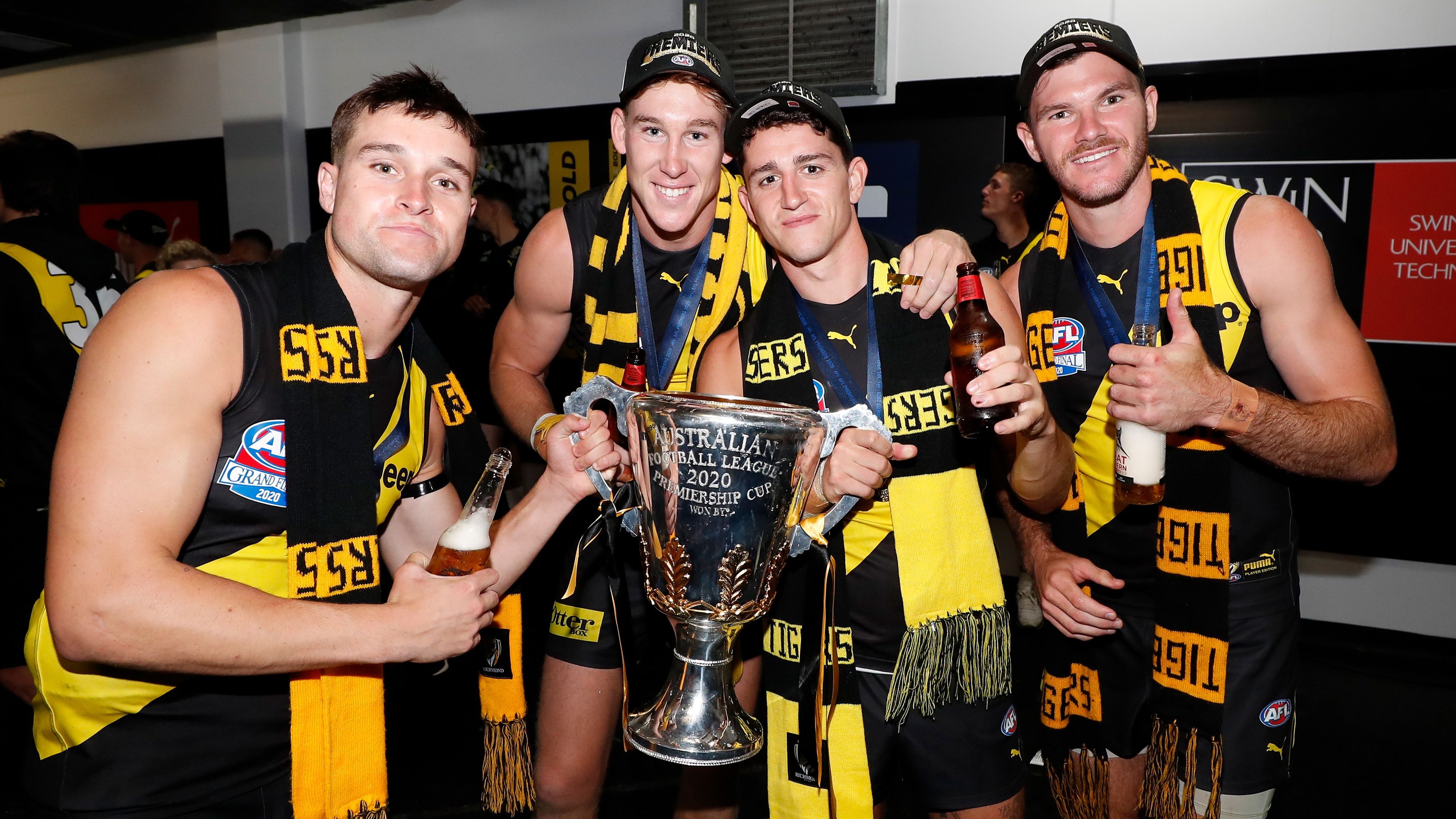 Jayden Short, Tom J. Lynch, Jason Castagna and Kamdyn McIntosh of the Tigers celebrate during the 2020 Toyota AFL Grand Final match between the Richmond Tigers and the Geelong Cats at The Gabba on October 24, 2020 in Brisbane, Australia.