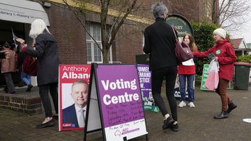 Voters walk into a pre-polling booth in Sydney, Australia, Friday, May 20, 2022. 