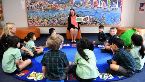 A teacher reads a story to young students at The Glenleighden School in Brisbane. (AAP)