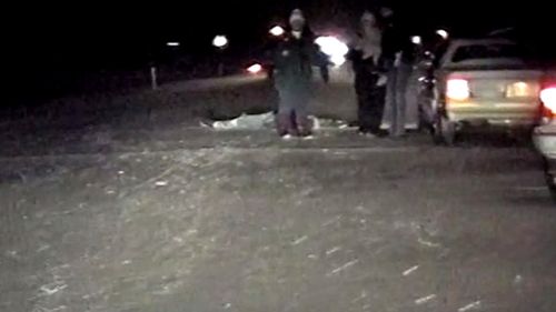 A still taken from police dash cam footage, showing Ricky Hochstetler's dead body on the road.
