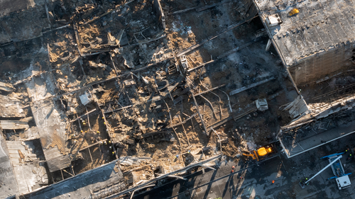 Ukrainian State Emergency Service firefighters work to take away debris at a shopping centre burned after a rocket attack in Kremenchuk, Ukraine, Tuesday, June 28, 2022. (AP Photo/Efrem Lukatsky)