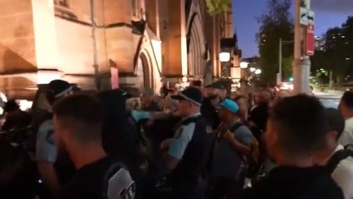 Pell supporters clash outside St Mary's Cathedral in Sydney.