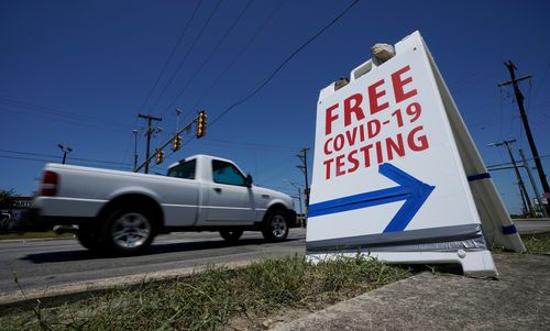 A truck passes a sign for free COVID-19 testing in San Antonio, Texas.