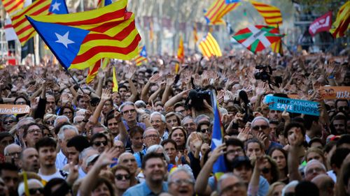 Pro-independence demonstrators cheer outside the Catalan parliament, in Barcelona, Spain. (AP)