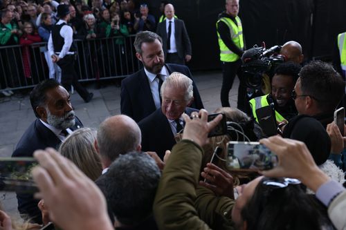 King Charles III greets members of the public queueing to see the Queen lying in state along the river Thames in Lambeth.