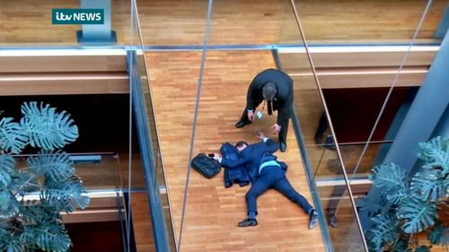 Steven Woolfe lying on the floor after an 'altercation' at the EU parliament. (AAP)
