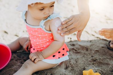 Baby at the beach. baby with sunscreen.