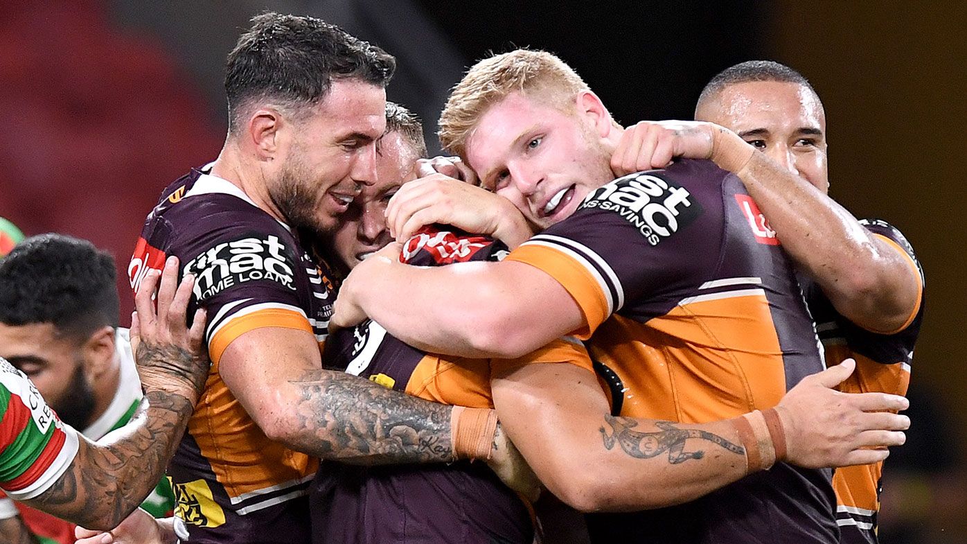 Kotoni Staggs of the Broncos is congratulated by team mates after scoring a try during the round 2 NRL match between the Brisbane Broncos and the South Sydney Rabbitoh