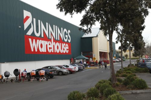 Melbourne, Australia - 23 July 2011: Bunnings is Australia's most successful hardware chain. Here is the outside of a store in Epping, Melbourne. Includes customers walking to the entrance and cars parked nearby.