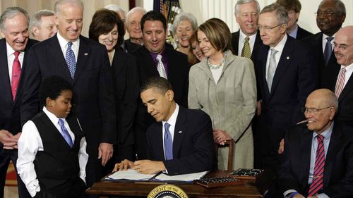 President Obama signs the landmark legislative achievement of his presidency, the Affordable Care Act, soon to be rebranded as Obamacare. The contentious health care law proved a millstone around Democrats' necks in midterm elections in 2010, giving the Republicans a solid majority in the House of Representatives. The conservative opposition managed to block most of Obama's agenda for the rest of his presidency. (AP)