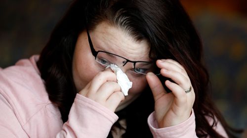 Lilly Ross wipes a tear from her eye as she talks about her deceased husband. (AAP)