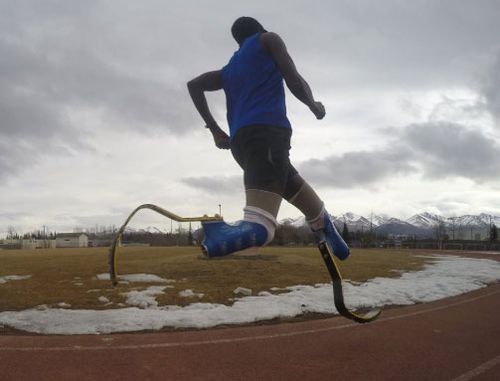 Amputee runner Marko Cheseto training on a track in Alaska.