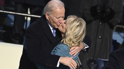 President Joe Biden gets a kiss from first lady Jill Biden after he took the oath office during the inauguration at the U.S. Capitol in Washington, Wednesday, Jan. 20, 2021