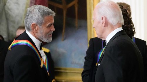  President Joe Biden shakes hands with actor, director and producer George Clooney during the Kennedy Center honorees reception at the White House in Washington, Dec. 4, 2022. Movie star and lifelong Democrat George Clooney is adding his voice to calls for Joe Biden to leave the presidential race. Clooney says in a New York Times opinion piece Wednesday that he loves Biden, but the party would lose the presidential race as well as any control in Congress with him as the nominee.