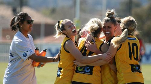 Claire O'Neill (centre) says she first thought the lump she felt was from a knock she copped during her recent club football grand final match.