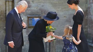Britain&#x27;s King Charles III and Camilla, the Queen Consort receive a bouquet from a girl as they leave the Llandaff Cathedral following a Service of Prayer and Reflection for the life of Queen Elizabeth II.