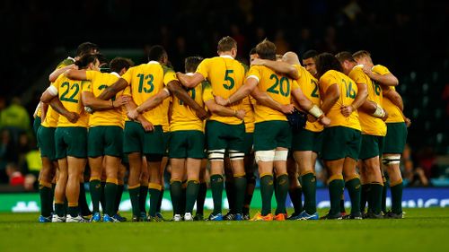 The Wallabies in a huddle after their crucial win. (Getty)